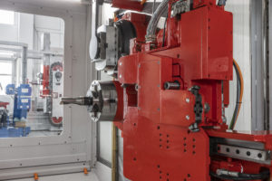 A close up of a red part on a horizontal machining center