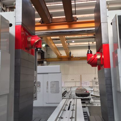 A double column machine with two, red RAM spindles in a warehouse